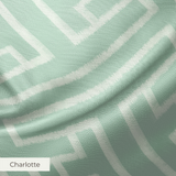 Greek key pattern in sage green and cream with geometric interlocking maze design