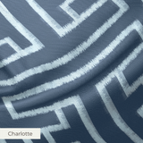 White geometric Greek key pattern on dark blue background