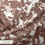 Brown and white speckled pattern with irregular organic shapes creating a mottled texture