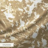 Abstract gold and white mottled pattern with organic shapes and speckled texture