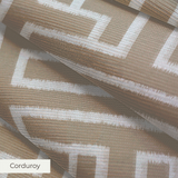 Greek key pattern in white on beige background with geometric maze-like design