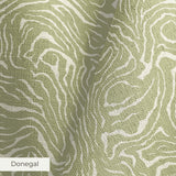 Abstract swirling pattern in white lines on sage green background, resembling flowing water or natur