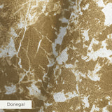 Abstract gold and white mottled pattern with organic shapes and speckled texture