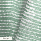Green and white horizontal wavy stripes pattern with distressed texture