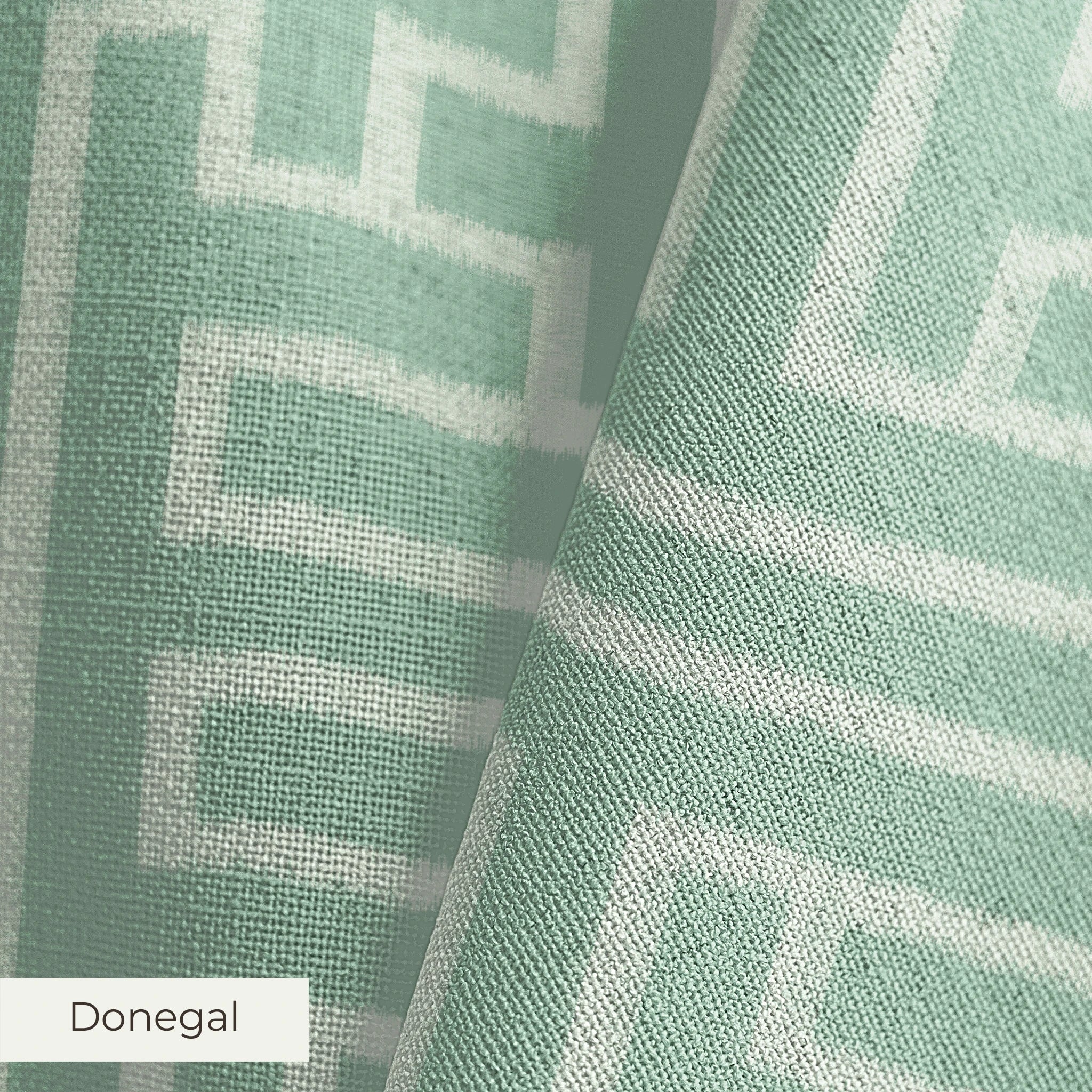 Greek key pattern in sage green and cream with geometric interlocking maze design