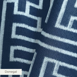 White geometric Greek key pattern on dark blue background