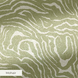 Abstract swirling pattern in white lines on sage green background, resembling flowing water or natur