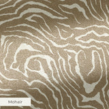 Swirling abstract pattern in tan and white resembling wood grain or marble texture