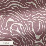 Swirling organic pattern in white lines on mauve-brown background creating flowing abstract texture