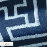 White geometric Greek key pattern on dark blue background