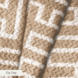 Greek key pattern in white on beige background with geometric maze-like design