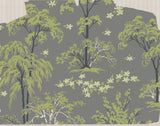 A close-up of a wallpaper or fabric archive featuring stylized green trees and white flowers on a medium gray background.