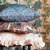 Disney Princess Tiana fabric pillows stacked sitting on a stool. Tiana wallpaper is displayed in the background.