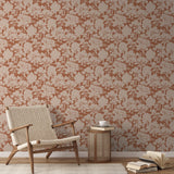 Silhouette pattern of trees and woodland scenery in beige on terracotta background